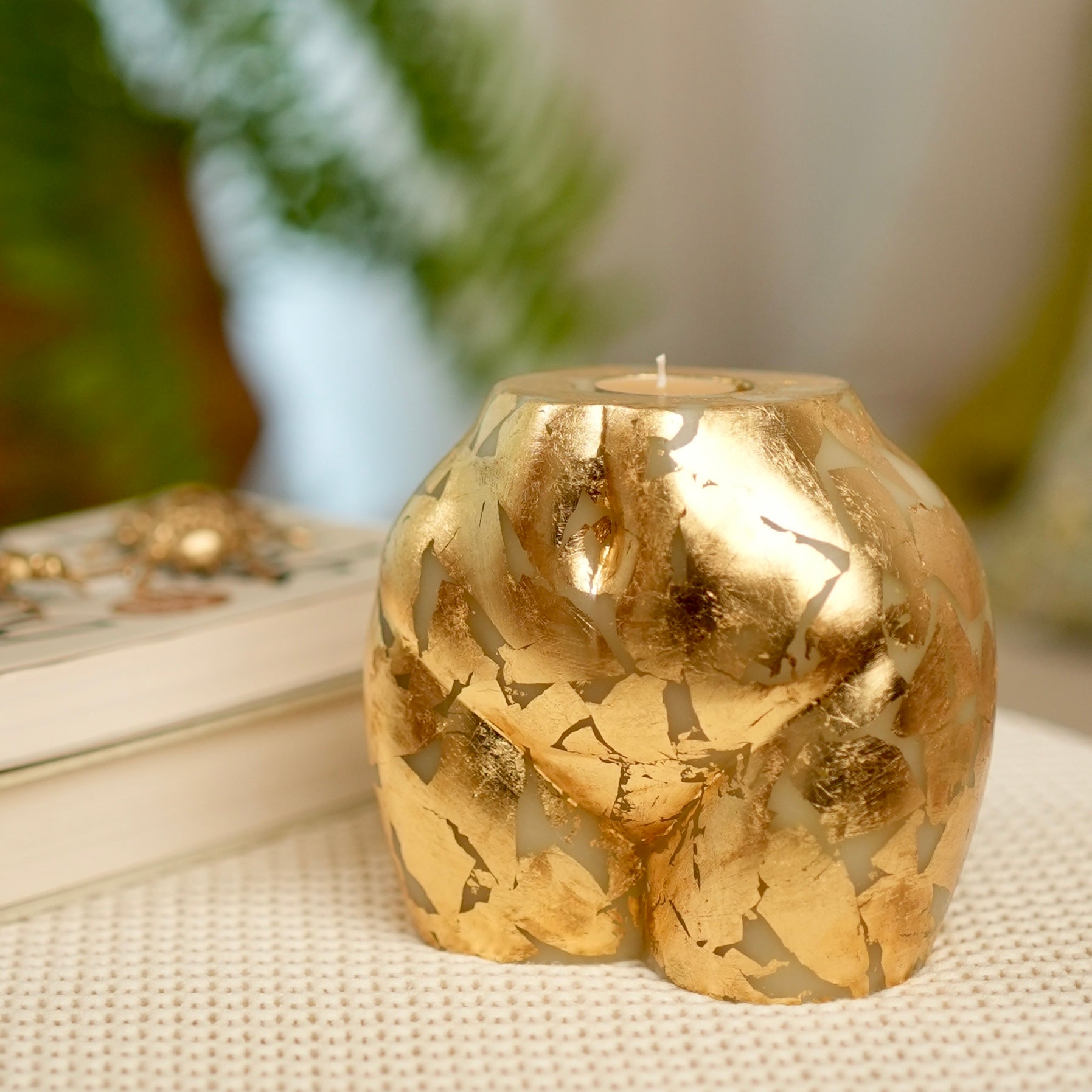 Sculpted Gold Leaf Cheeky Candle with a replaceable scented tealight