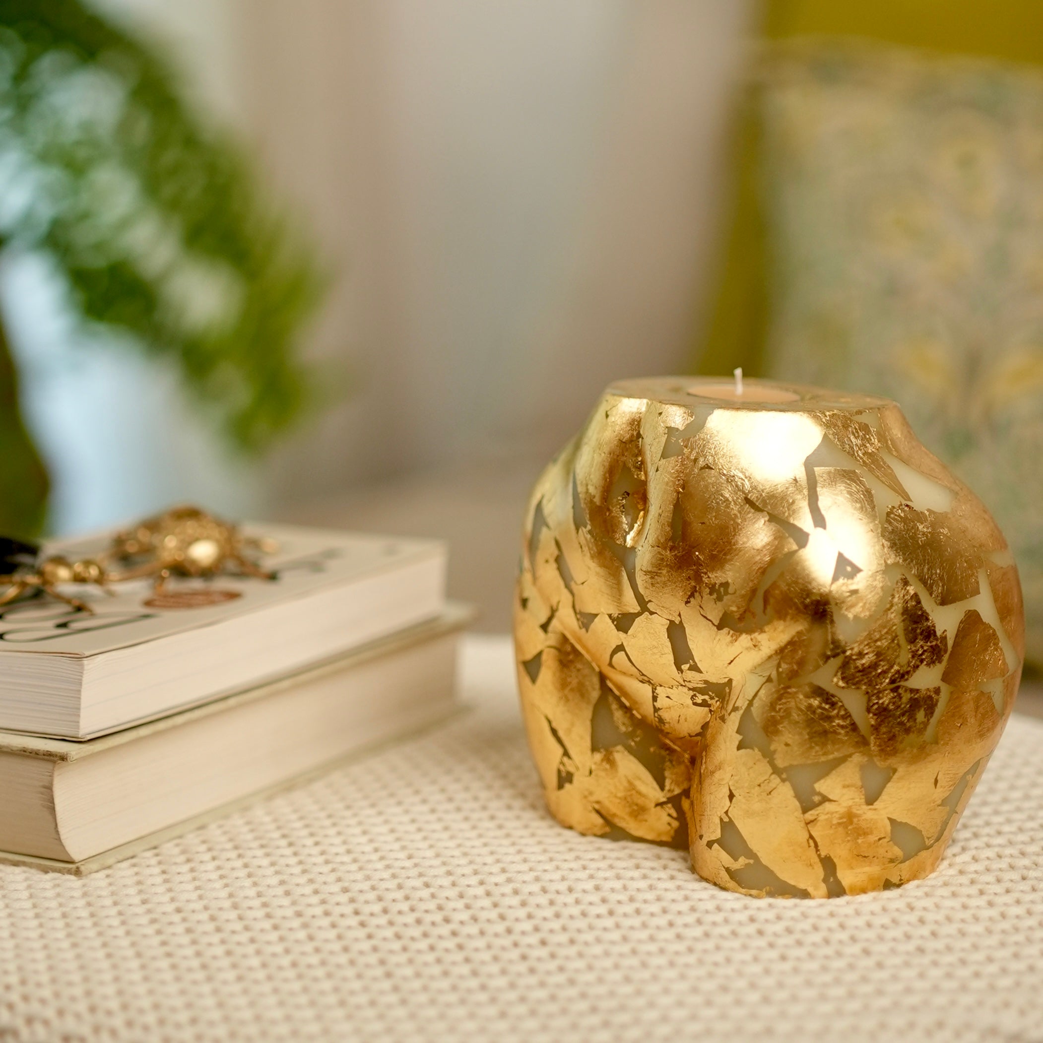Sculpted Gold Leaf Cheeky Candle with a replaceable scented tealight